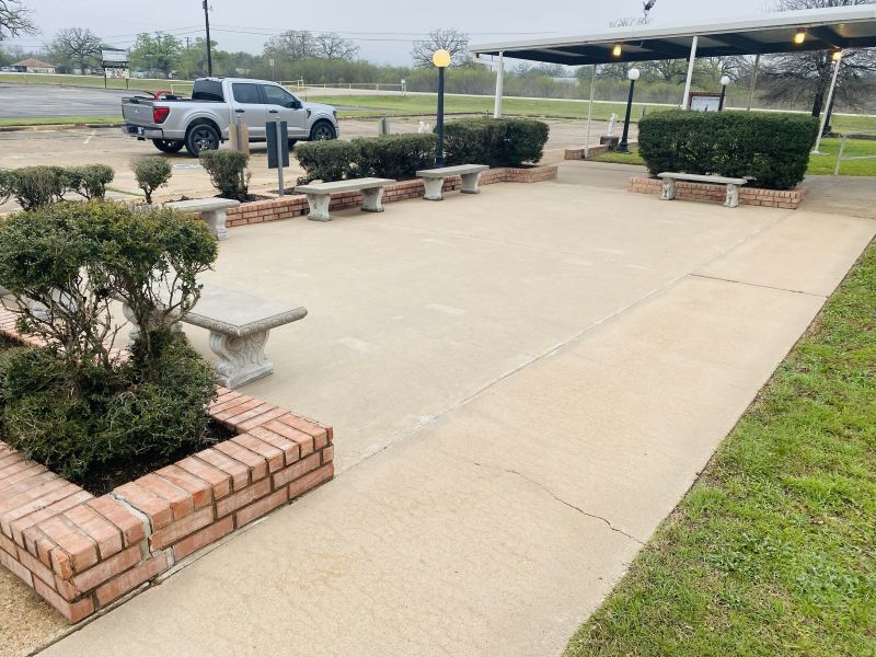 The same St. Ann courtyard patio after pressure washing, with clean, even concrete
