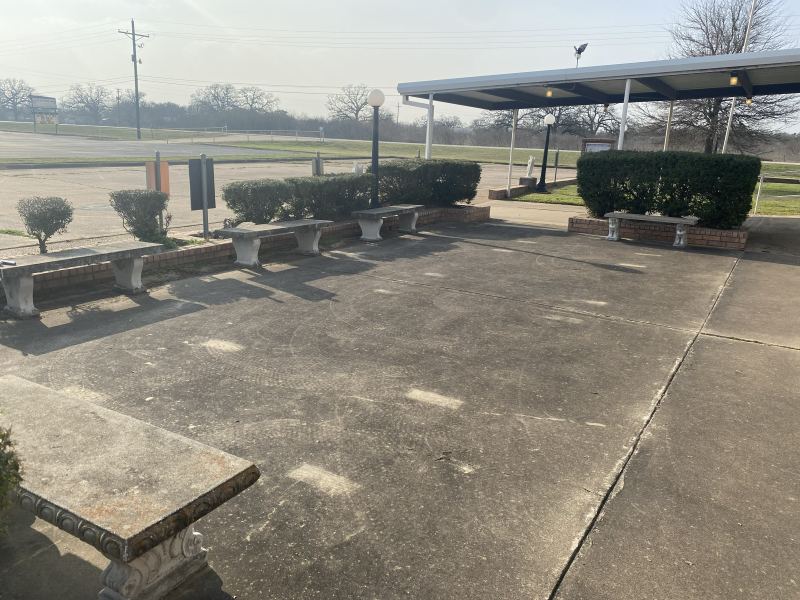 Courtyard patio at St. Ann Catholic Church in Somerville before cleaning, with dark stained concrete